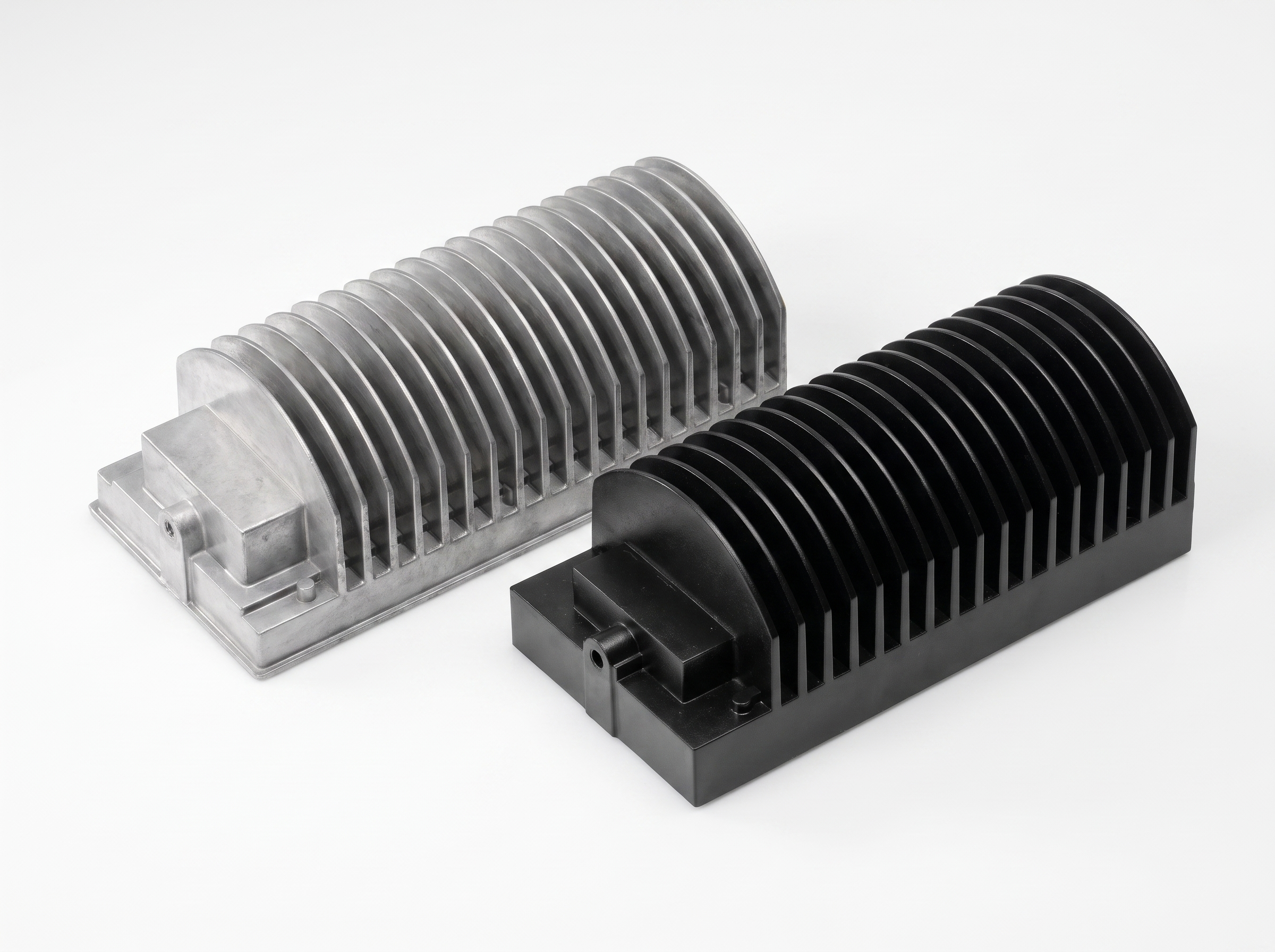 Two high-pressure die-cast aluminium LED housings with cooling fins: untreated and black-coated