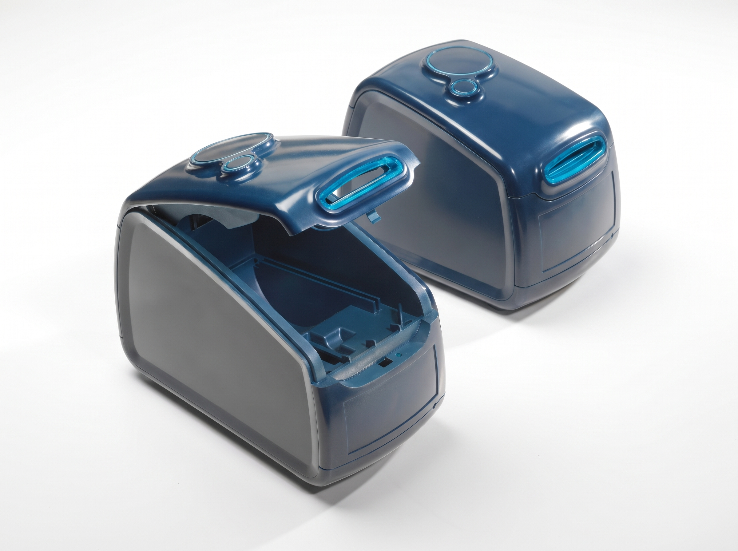 Two CNC-milled and painted ABS housings of a medicine dispenser in dark blue, one opened