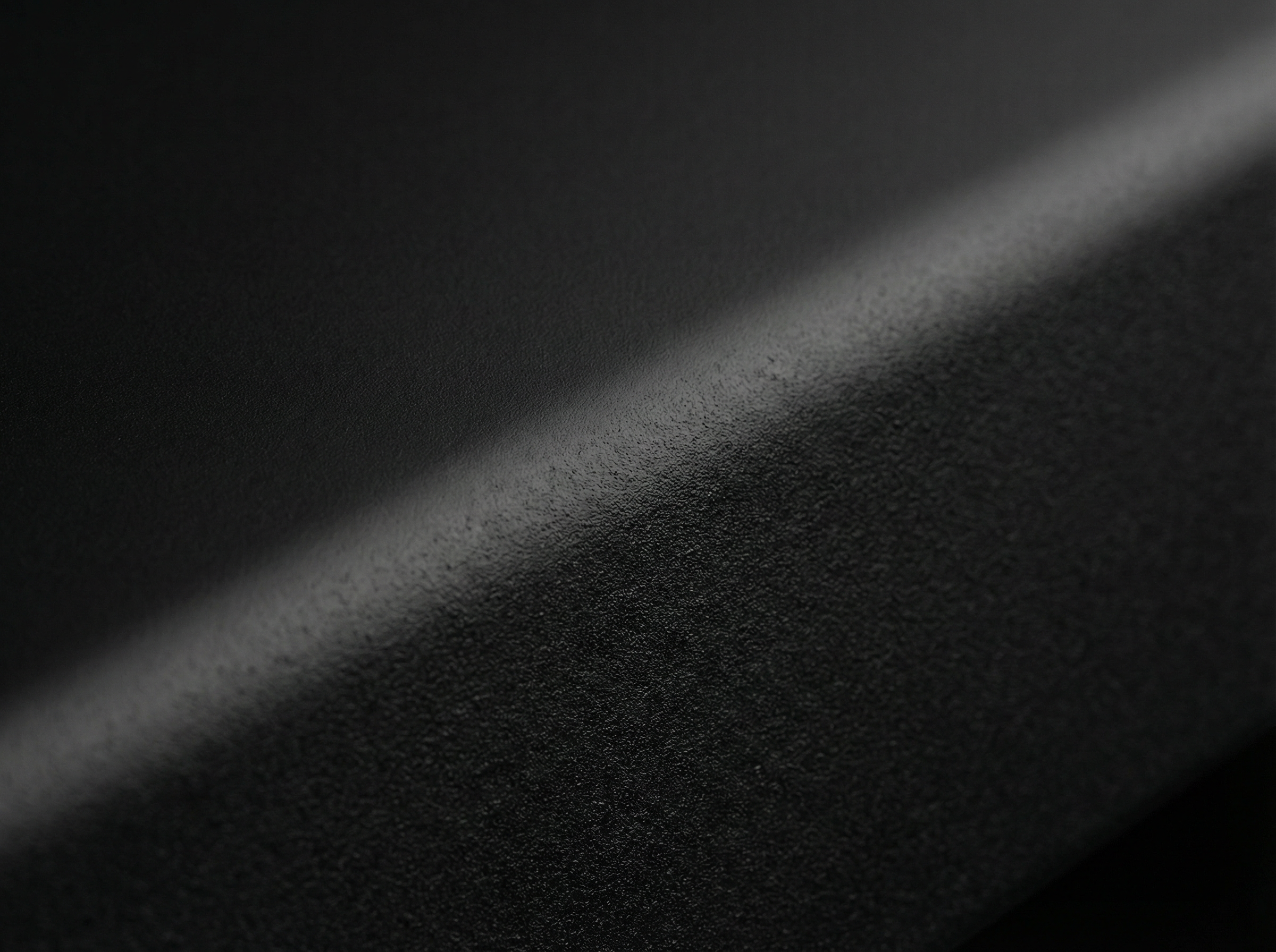 Close-up of a textured black coating on a cast aluminium surface